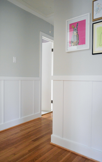 hallway with architectural interest including board and batten molding and outside corner edge