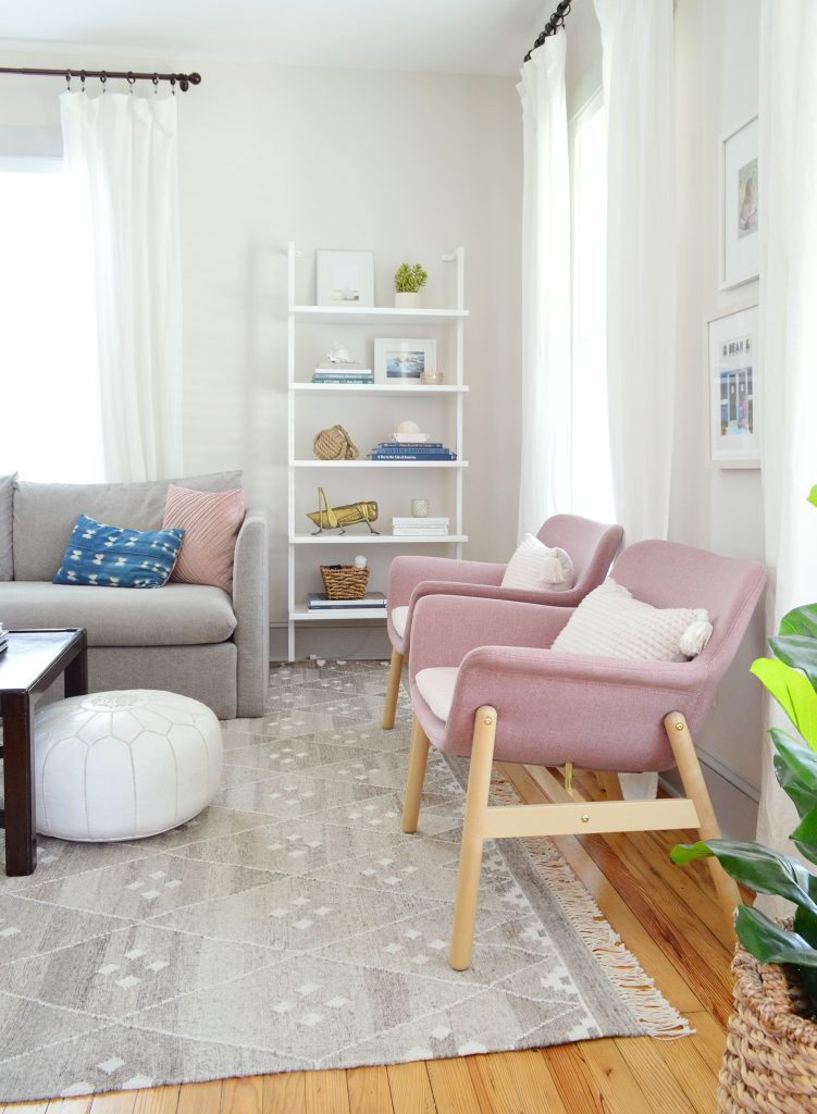 Pink Ikea Chairs And Open Bookcase In Beach House Living Room