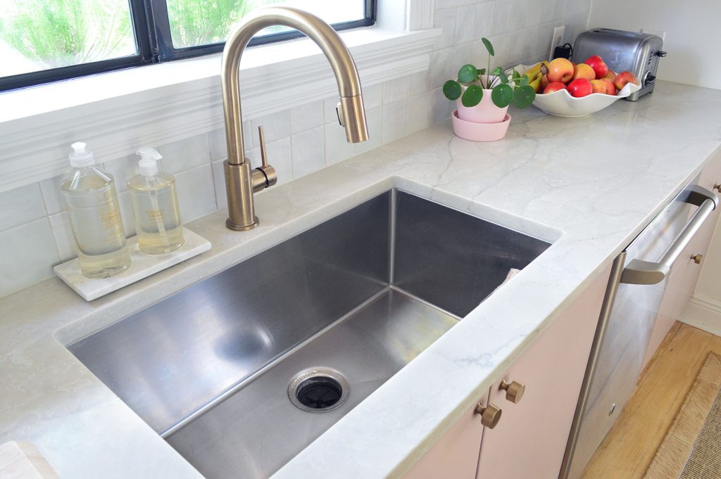 Deep Stainless Steel Sink And Gray Natural Quartz Countertops