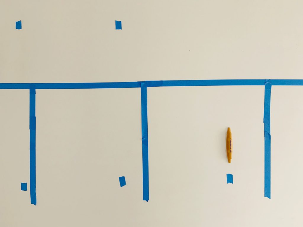 Marking Studs With Blue Painters Tape Using Stud Buddy Tool