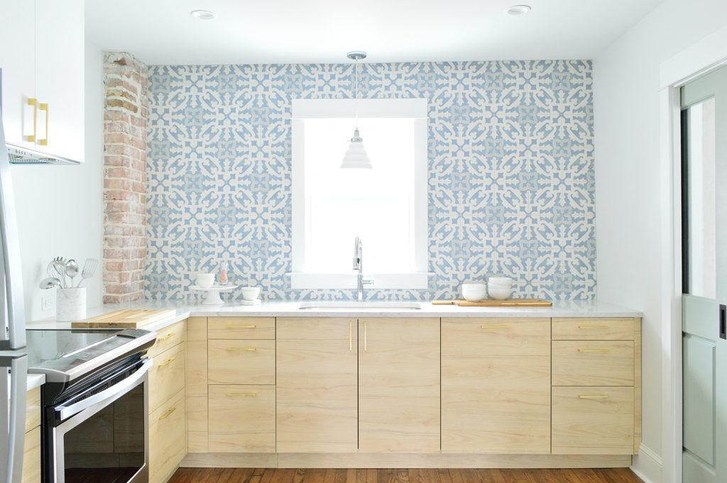 Wood Ikea Kitchen With Exposed Brick Chimney and Blue White Patterned Tile