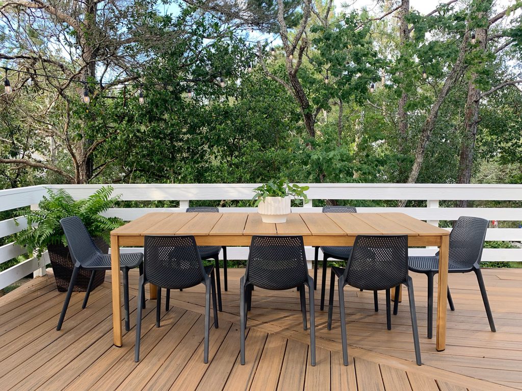 Metal Outdoor Dining Table With Eight Black Plastic Chairs