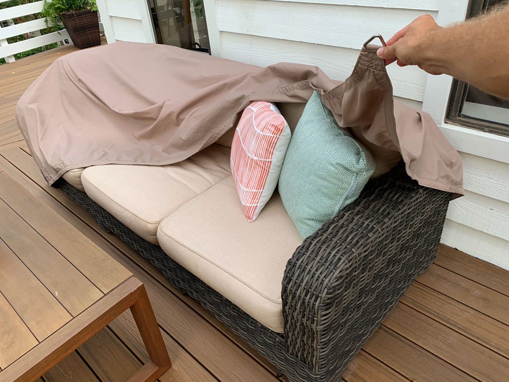 Waterproof Sail Shade Cover Being Pulled Over Outdoor Couch