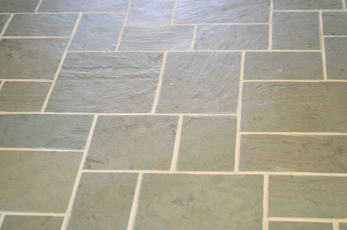 close up of clean grout between slate tile floor after Polyblend Grout Renew application