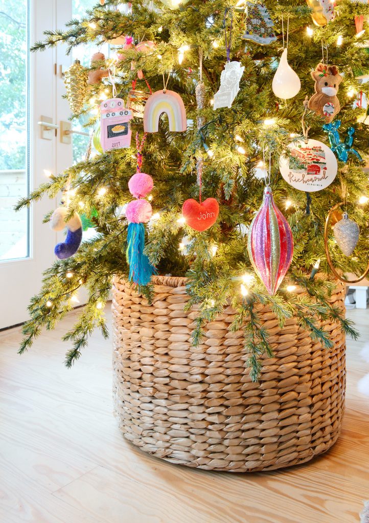 Woven Basket At Base Of Christmas Tree With Colorful Ornaments