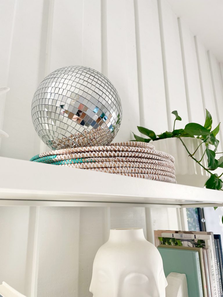 Decorative disco ball on top of shelves in office