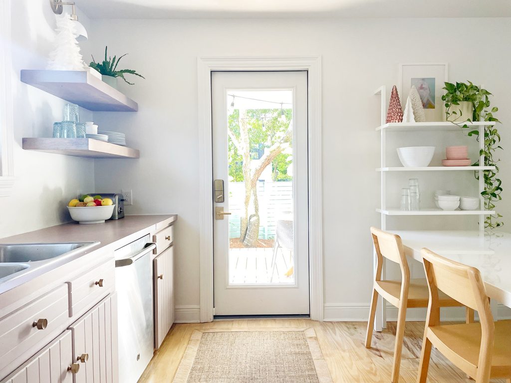 white kitchen with door out to patio