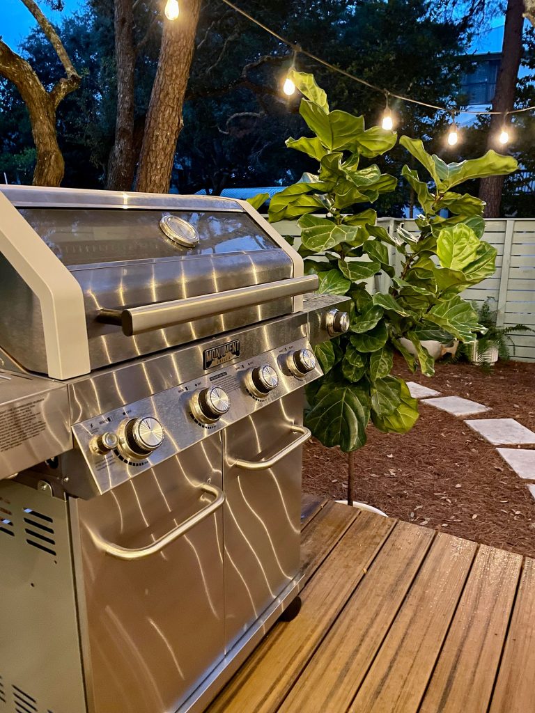 Detail photo of stainless steel grill at night 