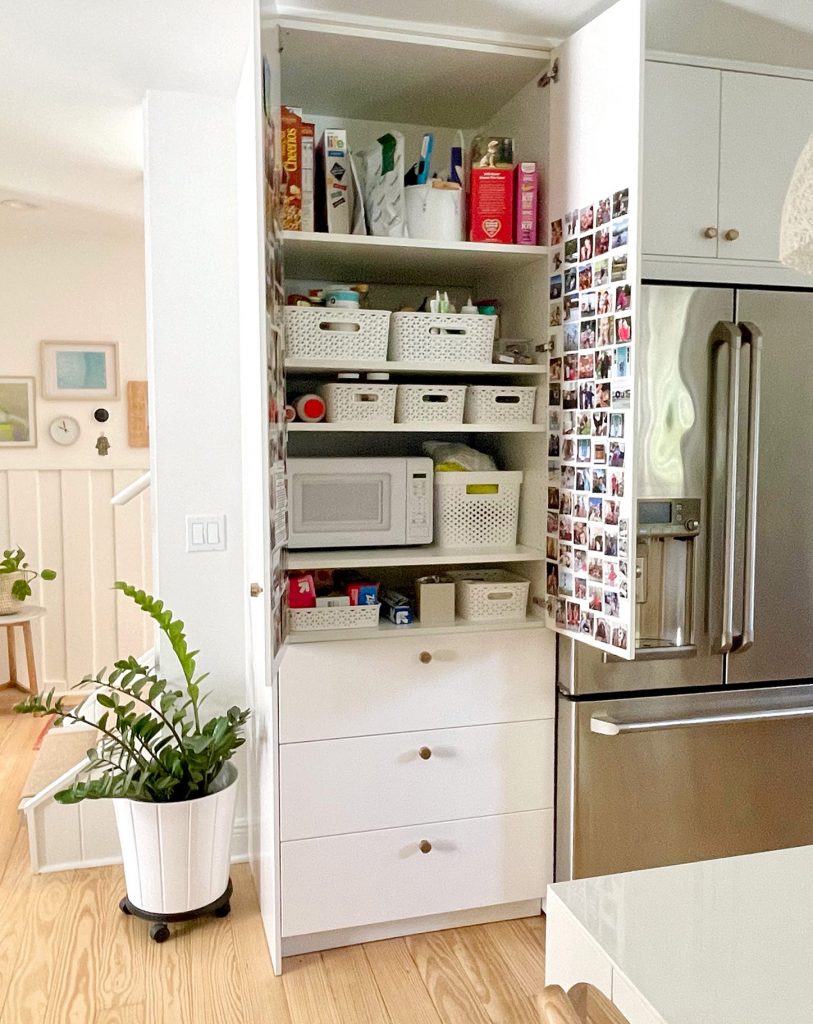 Ikea Kitchen Built-In Pantry With Doors Open to Show Shelf Organization With Baskets