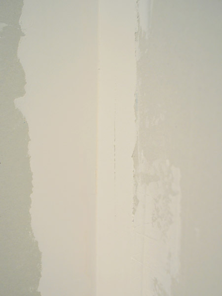 rough edges of drywall mud dried on wall