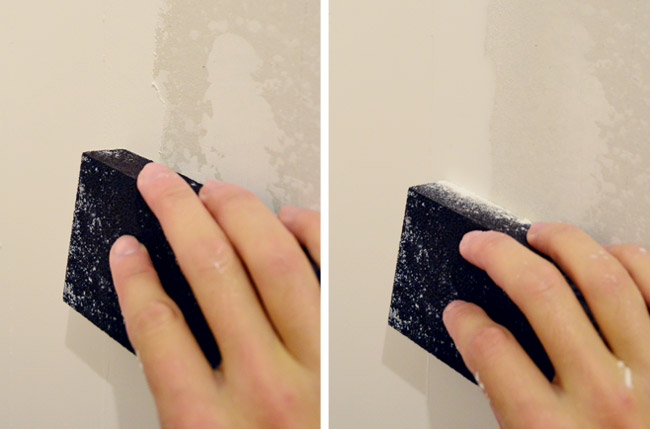rubbing wet sanding block on drywall mud to smooth