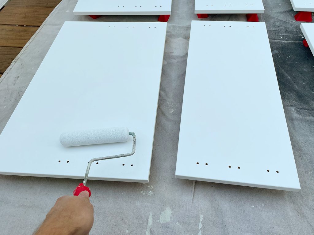 Applying Primer To Cabinet Door With Small Foam Roller