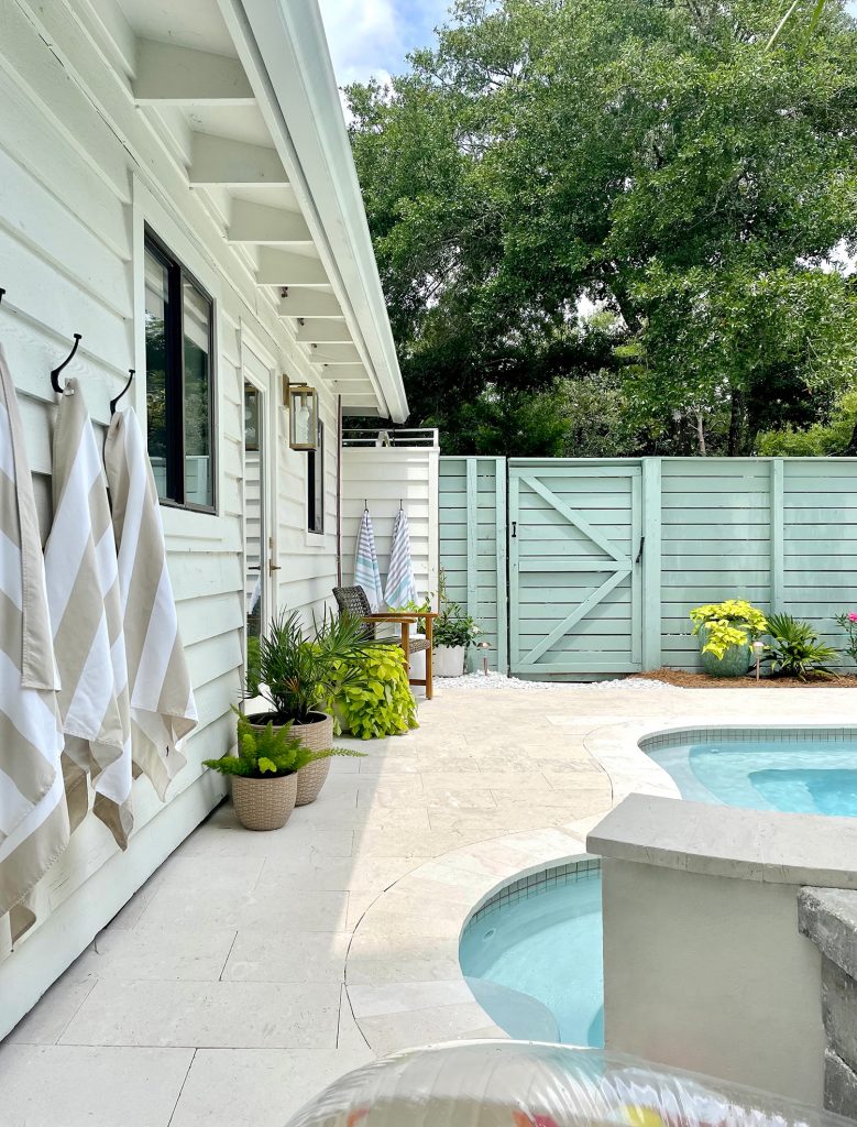 Pool patio area with cream colored shellstone 12x24 travertine tiles