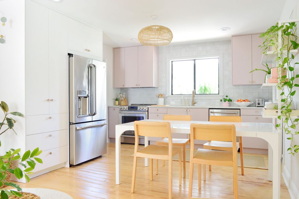 Side View Of Ikea Kitchen With White And Mauve Cabinets And Long Table